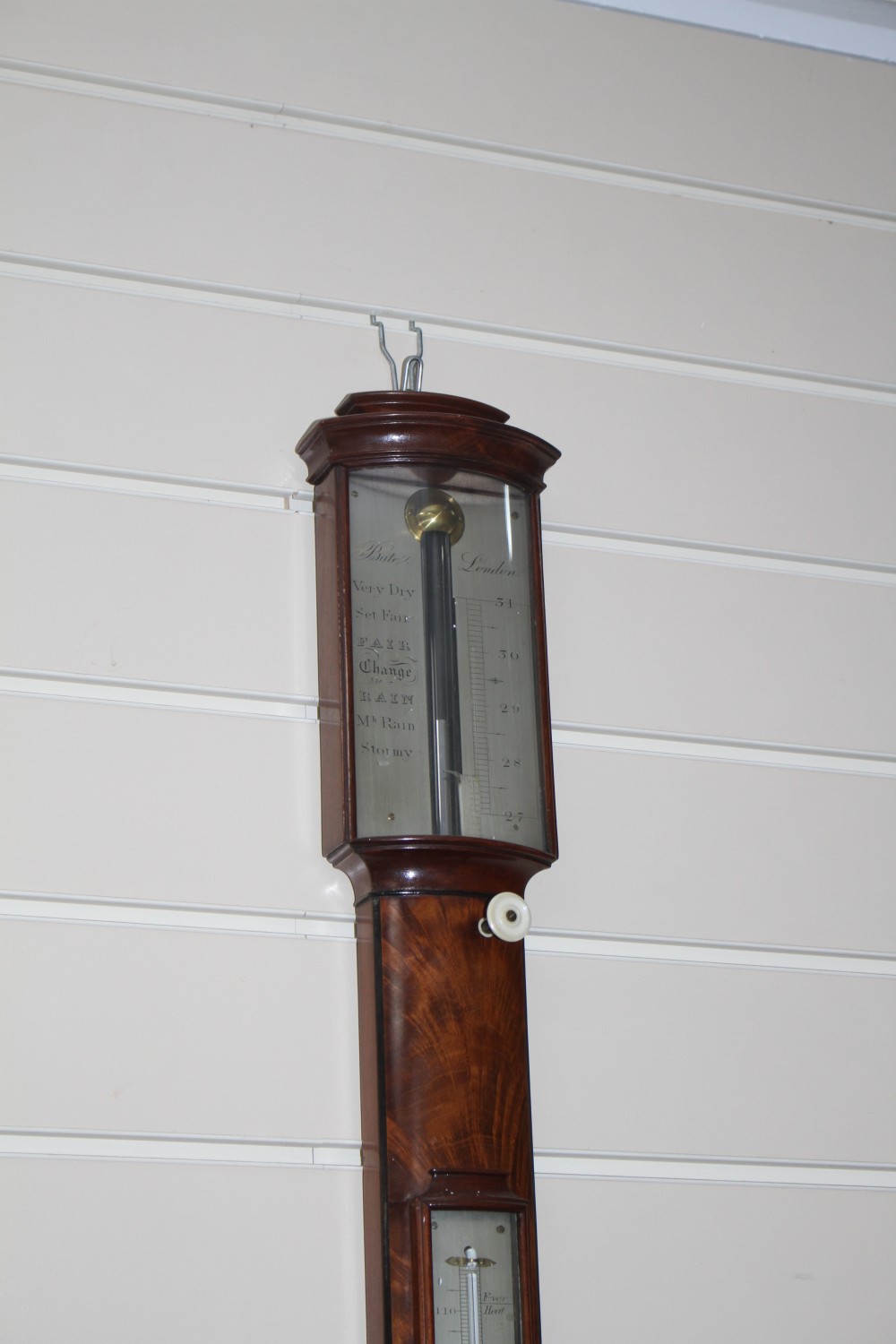 A Regency mahogany and ebonised bowfront stick barometer by Bate of London, with silvered scale and thermometer, 97cm